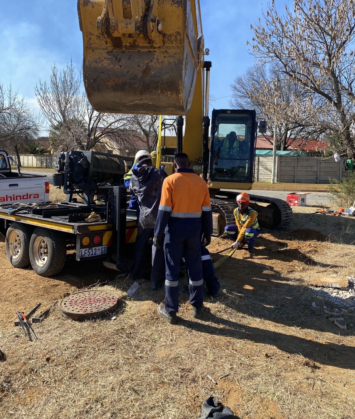 Intac Global crew in full PPE operating a crane lift on a live site