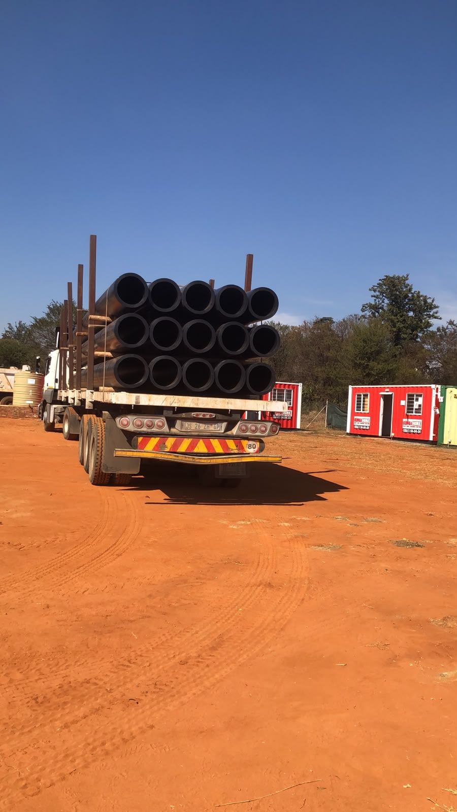 Bundles of HDPE pipe being delivered to site