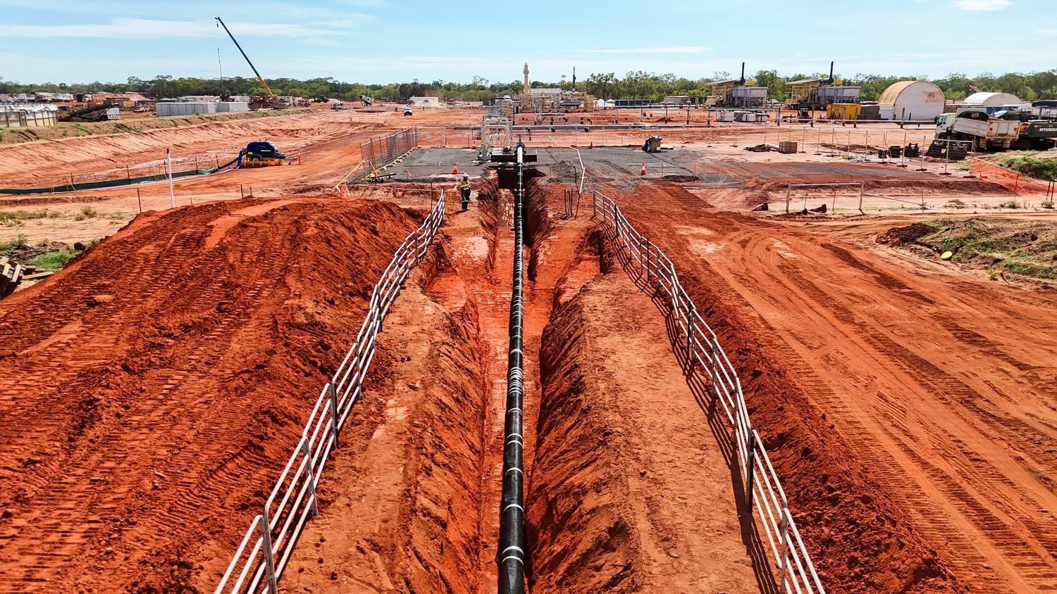 Long-distance pipeline being laid in an excavated trench